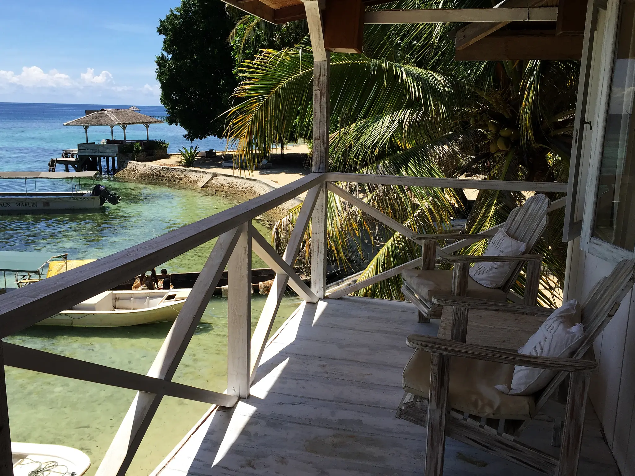 the economy room deck over the water, looking across to the jetty and dive boats